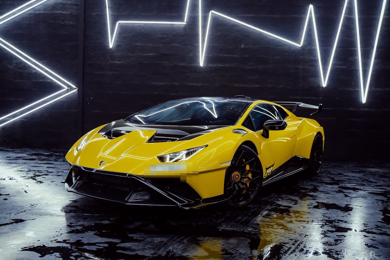 Rent a 2023 Lamborghini Huracán STO in Dubai — A race car with a number plate.